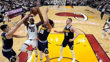 MIAMI, FLORIDA - JUNE 09: Jimmy Butler #22 of the Miami Heat drives to the basket against Michael Porter Jr. #1 and Aaron Gordon #50 of the Denver Nuggets in Game Four of the 2023 NBA Finals at Kaseya Center on June 09, 2023 in Miami, Florida. NOTE TO USER: User expressly acknowledges and agrees that, by downloading and or using this photograph, User is consenting to the terms and conditions of the Getty Images License Agreement. (Photo by Wilfredo Lee - Pool/Getty Images)