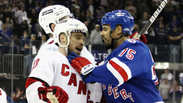 NEW YORK, NEW YORK - MAY 24: Ryan Reaves #75 of the New York Rangers confronts Max Domi #13 of the Carolina Hurricanes near the end of their game in Game Four of the Second Round of the 2022 Stanley Cup Playoffs at Madison Square Garden on May 24, 2022 in New York City. The Rangers defeated the Hurricanes 4-1. (Photo by Bruce Bennett/Getty Images)