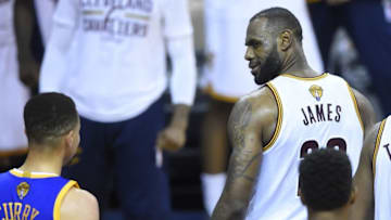 Jun 16, 2016; Cleveland, OH, USA; Cleveland Cavaliers forward LeBron James (23) stares at Golden State Warriors guard Stephen Curry (30) in the fourth quarter in game six of the NBA Finals at Quicken Loans Arena. Cleveland won 115-101. Mandatory Credit: David Richard-USA TODAY Sports