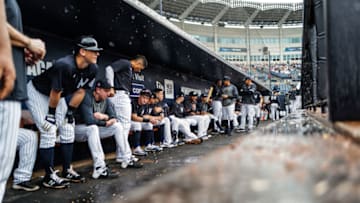 Yankee players wait out rain in their dugout. The Yanks had an 8-0 lead washed away in mid week simulated action. (Photo by Mark Brown/Getty Images)