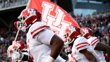 CINCINNATI, OHIO - DECEMBER 04: The Houston Cougars runs onto the field for the first half of the 2021 American Conference Championship against the Cincinnati Bearcats at Nippert Stadium on December 04, 2021 in Cincinnati, Ohio. (Photo by Emilee Chinn/Getty Images)