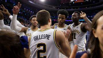 PHILADELPHIA, PA - DECEMBER 21: Justin Moore #5, Collin Gillespie #2, Saddiq Bey #41, and Dhamir Cosby-Roundtree #21 of the Villanova Wildcats react after defeating the Kansas Jayhawks at the Wells Fargo Center on December 21, 2019 in Philadelphia, Pennsylvania. The Villanova Wildcats defeated the Kansas Jayhawks 56-55. (Photo by Mitchell Leff/Getty Images)