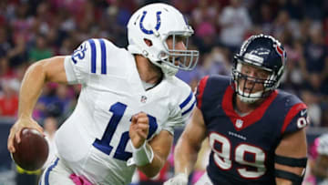 HOUSTON, TX- OCTOBER 09: Andrew Luck #12 of the Indianapolis Colts scrambles away from J.J. Watt #99 of the Houston Texans in the first quarter in a NFL game on October 9, 2014 at NRG Stadium in Houston, Texas. (Photo by Scott Halleran/Getty Images)