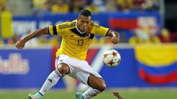 Oct 14, 2014; Harrison, NJ, USA; Colombia midfielder Fredy Guarin jumps over a Canada defender during the second half of their international friendly soccer game at Red Bull Arena. Colombia defeated Canada 1-0. Mandatory Credit: Adam Hunger-USA TODAY Sports