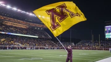 Nov 28, 2015; Minneapolis, MN, USA; A Minnesota Golden Gophers cheer leader waves a flag while standing out on the field in the second half against the Wisconsin Badgers at TCF Bank Stadium. The Badgers won 31-21. Mandatory Credit: Jesse Johnson-USA TODAY Sports