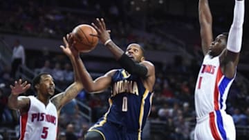 Nov 3, 2015; Auburn Hills, MI, USA; Indiana Pacers guard C.J. Miles (0) goes to the basket against Detroit Pistons guard Kentavious Caldwell-Pope (5) and guard Reggie Jackson (1) during the first quarter at The Palace of Auburn Hills. Mandatory Credit: Tim Fuller-USA TODAY Sports