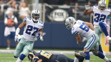 Sep 22, 2013; Arlington, TX, USA; Dallas Cowboys J.J. Wilcox (27) runs with the ball after an interception against the St. Louis Rams at AT&T Stadium. Mandatory Credit: Matthew Emmons-USA TODAY Sports