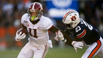 Alabama wide receiver Henry Ruggs III (11) tries to break a tackle by Auburn defensive back Roger McCreary (23) during the first half of the Iron Bowl in Jordan-Hare Stadium in Auburn Saturday, Nov. 30, 2019. [Staff Photo/Gary Cosby Jr.]Iron Bowl Alabama Vs Auburn