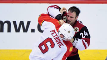 Mar 5, 2016; Glendale, AZ, USA; Arizona Coyotes center Kyle Chipchura (24) punches Florida Panthers defenseman Alex Petrovic (6) during the third period at Gila River Arena. Mandatory Credit: Matt Kartozian-USA TODAY Sports