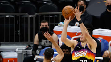 PHOENIX, ARIZONA - FEBRUARY 16: Dario Saric #20 of the Phoenix Suns attempts a shot over Timothe Luwawu-Cabarrot #9 of the Brooklyn Nets during the first half of the NBA game at Phoenix Suns Arena on February 16, 2021 in Phoenix, Arizona. NOTE TO USER: User expressly acknowledges and agrees that, by downloading and or using this photograph, User is consenting to the terms and conditions of the Getty Images License Agreement. (Photo by Christian Petersen/Getty Images)