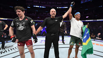 TORONTO, CANADA - DECEMBER 08: (R-L) Gilbert Burns of Brazil celebrates his victory over Olivier Aubin-Mercier of Canada in their lightweight fight during the UFC 231 event at Scotiabank Arena on December 8, 2018 in Toronto, Canada. (Photo by Josh Hedges/Zuffa LLC/Zuffa LLC via Getty Images)