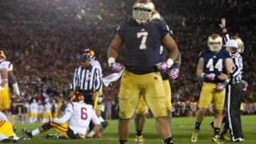 Oct 19, 2013; South Bend, IN, USA; Notre Dame Fighting Irish defensive end Stephon Tuitt (7) celebrates after sacking USC Trojans quarterback Cody Kessler (6) in the third quarter at Notre Dame Stadium. Notre Dame won 14-10. Mandatory Credit: Matt Cashore-USA TODAY Sports