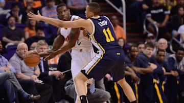 Apr 4, 2015; Phoenix, AZ, USA; Utah Jazz guard Dante Exum (11) guards Phoenix Suns guard Eric Bledsoe (2) at US Airways Center. The Suns won 87-85. Mandatory Credit: Joe Camporeale-USA TODAY Sports