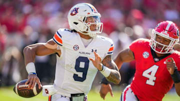 Auburn footballOct 8, 2022; Athens, Georgia, USA; Auburn Tigers quarterback Robby Ashford (9) runs away from Georgia Bulldogs linebacker Nolan Smith (4) during the first quarter at Sanford Stadium. Mandatory Credit: Dale Zanine-USA TODAY Sports