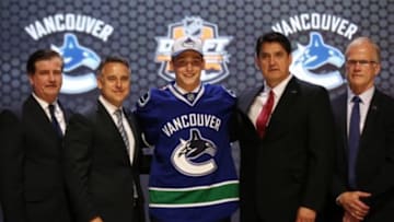 Jun 27, 2014; Philadelphia, PA, USA; Jake Virtanen poses for a photo with team officials after being selected as the number six overall pick to the Vancouver Canucks in the first round of the 2014 NHL Draft at Wells Fargo Center. Mandatory Credit: Bill Streicher-USA TODAY Sports