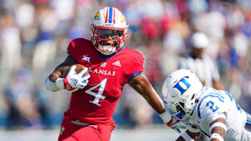 LAWRENCE, KS - SEPTEMBER 24: Devin Neal #4 of the Kansas Jayhawks runs the ball against Jaylen Stinson #2 of the Duke Blue Devils during the first half at David Booth Kansas Memorial Stadium on September 24, 2022 in Lawrence, Kansas. (Photo by Jay Biggerstaff/Getty Images)