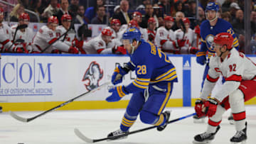 Apr 8, 2023; Buffalo, New York, USA; Buffalo Sabres left wing Zemgus Girgensons (28) skates with the puck as Carolina Hurricanes center Jesperi Kotkaniemi (82) defends during the second period at KeyBank Center. Mandatory Credit: Timothy T. Ludwig-USA TODAY Sports