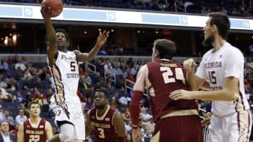 Mar 8, 2016; Washington, DC, USA; Florida State Seminoles guard Malik Beasley (5) shoots the ball as Boston College Eagles center Dennis Clifford (24) looks on in the first half during round one of the ACC Conference tournament at Verizon Center. Mandatory Credit: Geoff Burke-USA TODAY Sports