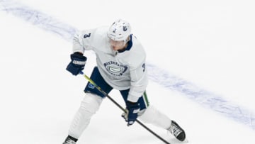 VANCOUVER, BC - JANUARY 4: Jack Rathbone #3 of the Vancouver Canucks shoots the puck on the first day of the Vancouver Canucks NHL Training Camp on January, 4, 2021 at Rogers Arena in Vancouver, British Columbia, Canada. (Photo by Rich Lam/Getty Images)