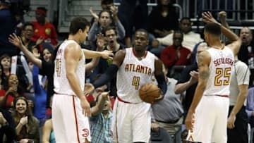 Mar 25, 2016; Atlanta, GA, USA; Atlanta Hawks forward Paul Millsap (4) celebrates a play with forward Kris Humphries (43) and forward Thabo Sefolosha (25) in the fourth quarter of their game against the Milwaukee Bucks at Philips Arena. The Hawks won 101-90. Mandatory Credit: Jason Getz-USA TODAY Sports