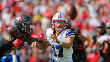 NORMAN, OK - OCTOBER 15: Quarterback Jason Bean #17 of the Kansas Jayhawks tosses the ball on an option play against linebacker David Ugwoegbu #2 of the Oklahoma Sooners in the second quarter at Gaylord Family Oklahoma Memorial Stadium on October 15, 2022 in Norman, Oklahoma. Oklahoma won 52-42. (Photo by Brian Bahr/Getty Images)