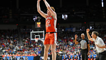 Mar 16, 2023; Des Moines, IA, USA; Illinois Fighting Illini guard Luke Goode (10) shoots the ball as Arkansas Razorbacks head coach Eric Musselman reacts during the first half at Wells Fargo Arena. Mandatory Credit: Jeffrey Becker-USA TODAY Sports