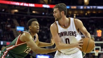 Dec 2, 2014; Cleveland, OH, USA; Cleveland Cavaliers forward Kevin Love (0) is defended by Milwaukee Bucks forward Jabari Parker (12) in the first quarter at Quicken Loans Arena. Mandatory Credit: David Richard-USA TODAY Sports