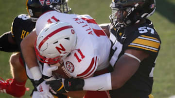 Iowa cornerback Matt Hankins, left, and left end Chauncey Golston tackle Nebraska tight end Austin Allen in the fourth quarter at Kinnick Stadium in Iowa City on Friday, Nov. 27, 2020.20201127 Iowavsneb