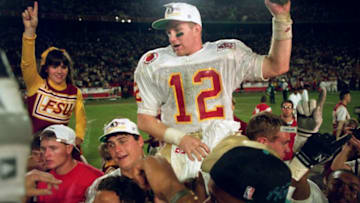 1 JAN 1994: WIDE RECEIVER MATT FRIER OF FLORIDA STATE CLUTCHES A HANDFUL OF TURF AS HE IS CARRIED ON THE SHLULDER OF FANS AND TEAMMATES AFTER THE SEMINOLES 18-16 DEFEAT OF THE UNIVERSITY OF NEBRASKA IN THE 1994 ORANGE BOWL. Mandatory Credit: Rick Stewar