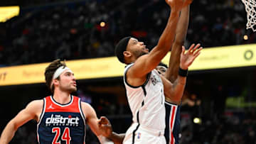 Feb 10, 2022; Washington, District of Columbia, USA; Brooklyn Nets forward Bruce Brown (1) shoots as Washington Wizards forward Corey Kispert (24) and center Thomas Bryant (13) look on during the first half at Capital One Arena. Mandatory Credit: Brad Mills-USA TODAY Sports