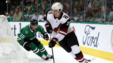 DALLAS, TX - OCTOBER 04: Dylan Strome #20 of the Arizona Coyotes skates the puck past Blake Comeau #15 of the Dallas Stars in the third period at American Airlines Center on October 4, 2018 in Dallas, Texas. (Photo by Ronald Martinez/Getty Images)