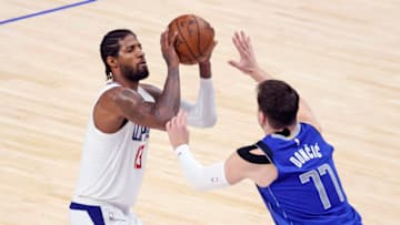 Jun 4, 2021; Dallas, Texas, USA; LA Clippers guard Paul George (13) shoots as Dallas Mavericks guard Luka Doncic (77) defends during the fourth quarter during game six in the first round of the 2021 NBA Playoffs. Mandatory Credit: Kevin Jairaj-USA TODAY Sports