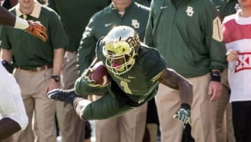 Dec 5, 2015; Waco, TX, USA; Baylor Bears wide receiver Corey Coleman (1) leaps over a Texas Longhorns defender during the second half at McLane Stadium. The Longhorns defeat the Bears 23-17. Mandatory Credit: Jerome Miron-USA TODAY Sports
