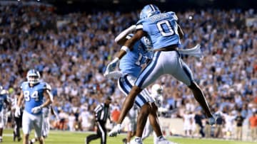 CHAPEL HILL, NORTH CAROLINA - SEPTEMBER 18: Josh Downs #11 celebrates with Emery Simmons #0 of the North Carolina Tar Heels after scoring a touchdown against the Virginia Cavaliers during the first half of their game at Kenan Memorial Stadium on September 18, 2021 in Chapel Hill, North Carolina. (Photo by Grant Halverson/Getty Images)