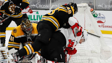Mar 28, 2021; Boston, Massachusetts, USA; Boston Bruins defenseman Matt Grzelcyk (48) knocks down New Jersey Devils left wing Miles Wood (44) battling for the puck at the side of the net during the second period at TD Garden. Mandatory Credit: Winslow Townson-USA TODAY Sports