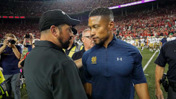 Sep 3, 2022; Columbus, Ohio, USA; Ohio State Buckeyes head coach Ryan Day shakes hands with Notre Dame Fighting Irish head coach Marcus Freeman following a game at Ohio Stadium. Ohio State won 21-10. Mandatory Credit: Adam Cairns-USA TODAY Sports
