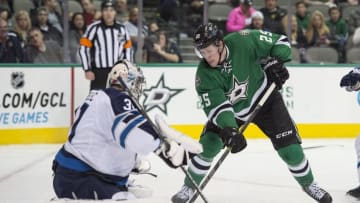 Jan 15, 2015; Dallas, TX, USA; Dallas Stars right wing Brett Ritchie (25) tries to get the puck past Winnipeg Jets goalie Ondrej Pavelec (31) during the second period at the American Airlines Center. Mandatory Credit: Jerome Miron-USA TODAY Sports