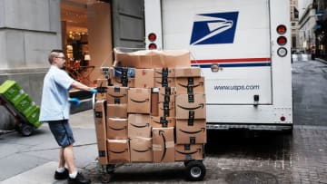 NEW YORK, NY - OCTOBER 11: A US Postal worker delivers Amazon boxes outside of the New York Stock Exchange (NYSE) on October 11, 2018 in New York City. Following a massive sell-off of over 800 points yesterday, the Dow Jones Industrial Average fell over 100 points in morning trading. (Photo by Spencer Platt/Getty Images)