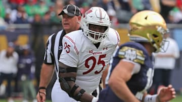 CHICAGO, ILLINOIS - SEPTEMBER 25: Keeanu Benton #95 of the Wisconsin Badgers chases Jack Coan #17 of the Notre Dame Fighting Irish at Soldier Field on September 25, 2021 in Chicago, Illinois. Notre Dame defeated Wisconsin 41-13. (Photo by Jonathan Daniel/Getty Images)