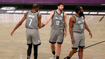NEW YORK, NEW YORK - JANUARY 25: Kevin Durant #7 high fives Joe Harris #12 as James Harden #13 of the Brooklyn Nets (Photo by Sarah Stier/Getty Images)