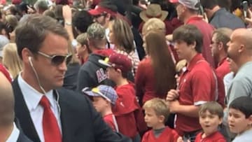 Coach Lane Kiffin "fist-bumps" a young Alabama fan at the Walk of Champions. Photo Credit: Meredith Hornsby