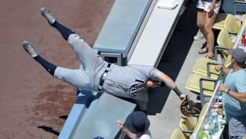 Jul 27, 2016; Los Angeles, CA, USA; Tampa Bay Rays first baseman Logan Morrison (7) falls into the stands after catching a foul ball by Los Angeles Dodgers left fielder Howie Kendrick (not pictured) in the seventh inning at Dodger Stadium. The Rays defeated the Dodgers 3-1. Mandatory Credit: Kirby Lee-USA TODAY Sports