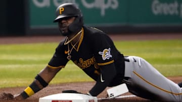 Aug 9, 2022; Phoenix, Arizona, USA; Pittsburgh Pirates second baseman Rodolfo Castro (14) loses his iPhone as he slides into third base against the Arizona Diamondbacks during the fourth inning at Chase Field. Mandatory Credit: Joe Camporeale-USA TODAY Sports