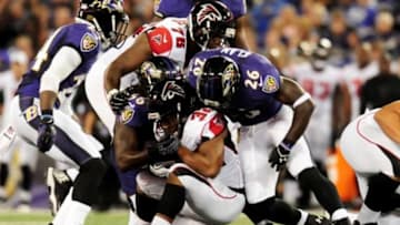 Aug 15, 2013; Baltimore, MD, USA; Atlanta Falcons running back Jacquizz Rodgers (32) is tackled by Baltimore Ravens linebacker Josh Bynes (56) and safety Matt Elam (26) at M&T Bank Stadium. Mandatory Credit: Evan Habeeb-USA TODAY Sports