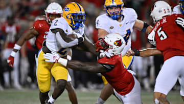 Oct 22, 2022; Louisville, Kentucky, USA; Pittsburgh Panthers running back Israel Abanikanda (2) breaks the tackle of Louisville Cardinals defensive lineman YaYa Diaby (6) as he runs the ball during the first quarter at Cardinal Stadium. Mandatory Credit: Jamie Rhodes-USA TODAY Sports