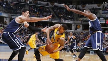 Mar 19, 2016; Indianapolis, IN, USA; Indiana Pacers guard George Hill (3) gets fouled as he is guarded by Oklahoma City Thunder center Enes Kanter (11) and forward Kevin Durant (35) at Bankers Life Fieldhouse. Oklahoma City defeats Indiana 115-111. Mandatory Credit: Brian Spurlock-USA TODAY Sports
