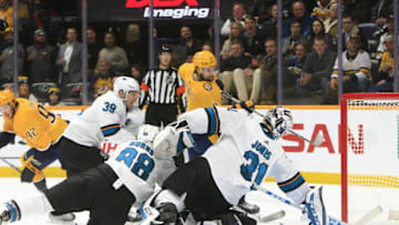 NASHVILLE, TN - DECEMBER 10: With San Jose Sharks center Logan Couture (39) and defenseman Brent Burns (88) defending, goalie Martin Jones (31) makes a save against Nashville Predators left wing Filip Forsberg (9) during the NHL game between the Nashville Predators and San Jose Sharks, held on December 10, 2019, at Bridgestone Arena in Nashville, Tennessee. (Photo by Danny Murphy/Icon Sportswire via Getty Images)