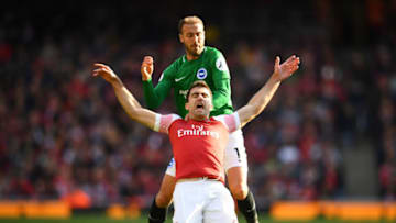 LONDON, ENGLAND - MAY 05: Sokratis Papastathopoulos of Arsenal is challenged by Glenn Murray of Brighton and Hove Albion during the Premier League match between Arsenal FC and Brighton & Hove Albion at Emirates Stadium on May 05, 2019 in London, United Kingdom. (Photo by Clive Mason/Getty Images)