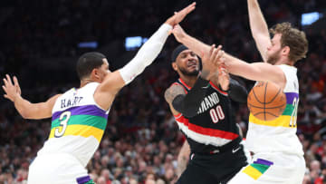 PORTLAND, OREGON - FEBRUARY 21: Carmelo Anthony #00 of the Portland Trail Blazers loses the ball against Josh Hart #3 and Nicolo Melli #20 of the New Orleans Pelicans . (Photo by Abbie Parr/Getty Images)