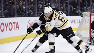 Mar 19, 2016; Los Angeles, CA, USA; Boston Bruins left wing Brad Marchand (63) and Los Angeles Kings defenseman Alec Martinez (27) battle for the puck during the first period at Staples Center. Mandatory Credit: Kelvin Kuo-USA TODAY Sports